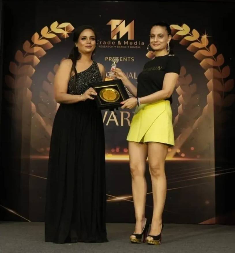 Mystical Auras founder receiving the Best Tarot Card Reader Award from Bollywood actress Amisha Patel at a prestigious award ceremony in Recognition of excellence in Tarot and Healing Services.